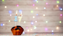 Happy Birthday Background With Muffin And Number Of Candles On Light Bulbs Bokeh Background. Greeting Card Happy Birthday Copy Space With Number  17