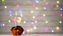 Happy Birthday Background With Muffin And Number Of Candles On Light Bulbs Bokeh Background. Greeting Card Happy Birthday Copy Space With Number  43