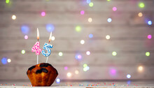 Happy Birthday Background With Muffin And Number Of Candles On Light Bulbs Bokeh Background. Greeting Card Happy Birthday Copy Space With Number  45