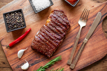 grilled beef steak on wooden background 