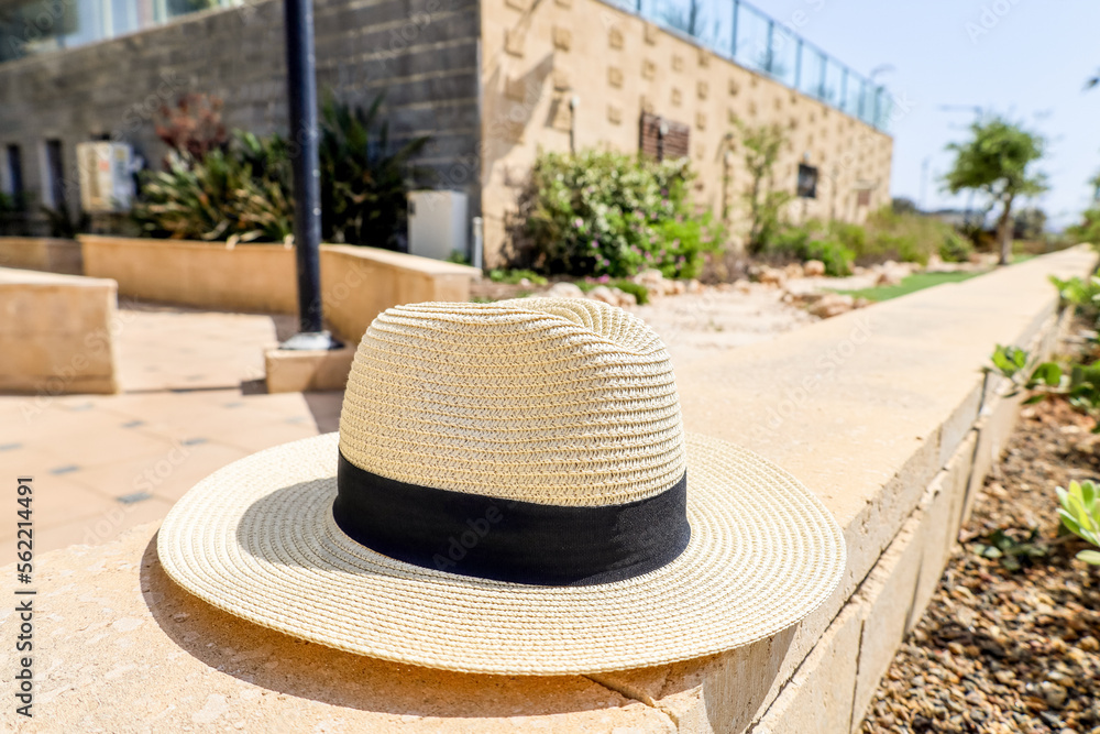 Summer hat on stone fence in city, closeup