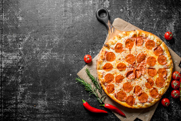 Canvas Print - Pepperoni pizza with chili, tomatoes and rosemary.