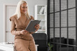 © Pixel-Shot - Mature bank manager with clipboard in office