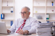 © Elnur - Old male employee and too much work in the office
