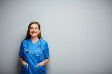 Wall Mural - Nurse in blue medical suit, portrait with copy space on wall.