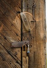 Close Up Of Old Textured Barn Wood Door With Padlocks