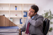 © Elnur - Young male employee working in the office