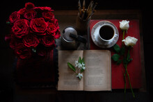 Reading A Book In Study With Roses And Coffee 