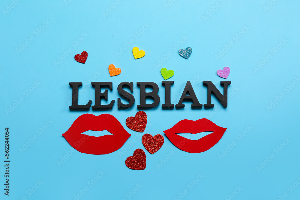 Word LESBIAN, paper lips and hearts on blue background. Valentine's Day celebration