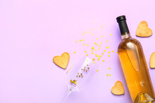 Bottle Of Wine, Glass With Sequins And Cookies On Lilac Background. Valentines Day Celebration