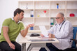 © Elnur - Young male patient visiting old male doctor