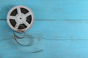 Wall Mural - Old film strip on wooden background.