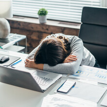 Woman At Work In The Office Sleeping On The Desk