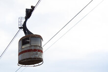 Horizontal Photo. Vintage Old Cabin Of An Abandoned Cable Car In Georgian City Of Tbilisi Against Light Sky. Concept Of Abandonment, Old Age. Tourist Route, Journey, Vacation, Vacation. Vintage. Trip