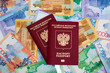 © brajianni - Top view. Red biometric Russian passport. Paper cash banknotes of the Republic of Kazakhstan. Concept of moving, relocation, immigration, buying citizenship, tourism. Currency exchange. Money for pay