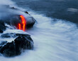 © Cavan Images - Lava drips from rocks into the Pacific Ocean.