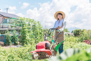 Sticker - 畑を小型トラクターで耕す農家のアジア人女性（農業・田舎暮らし）