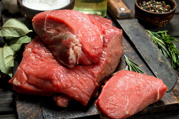 Raw meat. Fresh beef with spices and an old knife.