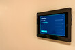 © Thomas - Close up image of a meeting room reservation system screen that is integrated into a smart building.