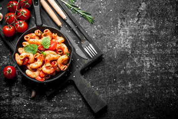 Sticker - Pasta in pan on a cutting Board with tomatoes and rosemary.