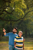 Fototapeta Uliczki - Young indian man with his father at park