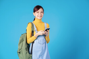 Poster - Young Asian student posing on blue background