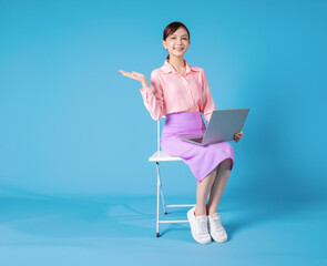 Wall Mural - Photo of young Asian businesswoman sitting on chair