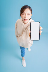 Poster - Full length image of young Asian girl using smartphone