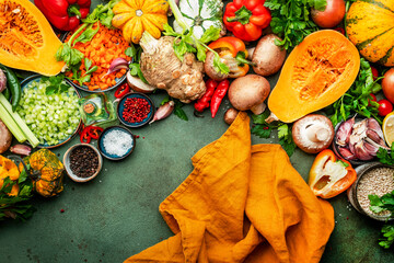 Wall Mural - Food background. Vegetables, mushrooms, roots, spices - ingredients for vegan, cooking. Orange kitchen towel. Healthy eating, diet, comfort slow food. concept. Rustic table, top view