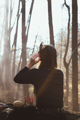 Wall Mural - Celtic folk tradition scenic photography. Picture of mysterious woman in black dress with forest on background. High quality wallpaper. Photo concept for ads, travel blog, magazine, article