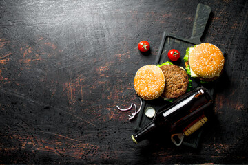 Sticker - Burgers and beer in a bottle on the cutting Board.