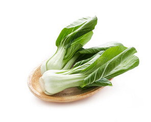 Wall Mural - pile of baby bok choy or pak choy in wood plate isolated on white background. heap of bok choy isolated. green bok choy isolated                                                    