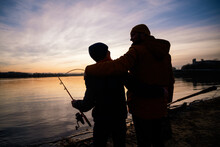 Father And Son Are Ready For Fishing On Winter Day. River Fishing.