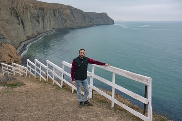 Man walking in nature, beautiful sea view, hiking, adventure, active and healthy lifestyle, ecotourism.