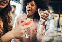 Cheerful Businesswomen Holding Drinks In Hotel