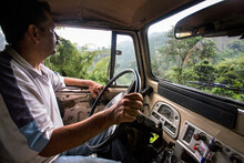 A Man Drives An Old Truck On A Rural Coffee Farm In Colombia.