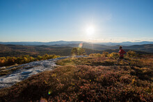 Trail Running Along The Summit Of Foss Mt. With The Setting Sun And White Mountains In The Background.