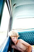 A Boy Rests In An Old Dodge Dart