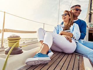 Wall Mural - Smile, happy and couple on a yacht at sea, summer travel and ocean adventure in Spain. Peace, hug and man and woman on a boat for a luxury cruise, sailing and happiness on holiday on the water