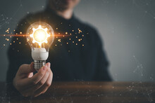 Innovation Design Concept. Hand Holding Light Bulb For New Idea Brain Storming Creative Inspiration.