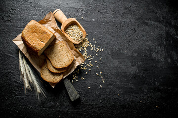 Wall Mural - Fresh baked bread with spikelets and grains.