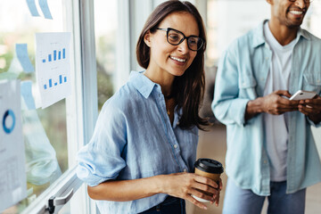 Poster - Female sales executive talking to her colleagues in an office