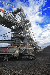 Wall Mural - Bucket-wheel excavator during excavation at the surface mine. Huge excavator on open pit mine.