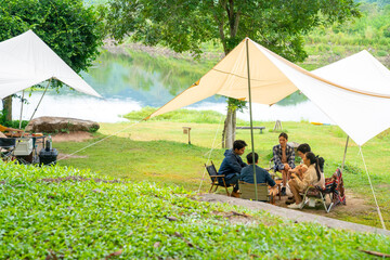 group of asian man and woman friends having breakfast and making brewed coffee at camp in the mornin