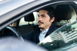© ADDICTIVE STOCK - Young Hispanic male driver sitting in modern car