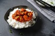 © vm2002 - Homemade sweet and sour chilli chicken served with jasmine rice, selective focus