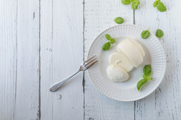 Wall Mural - Mozzarella cheese on white background with space for text. Flat lay