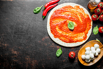 Sticker - Preparation pizza. Rolled out dough with tomato paste, chili pepper and mozzarella.