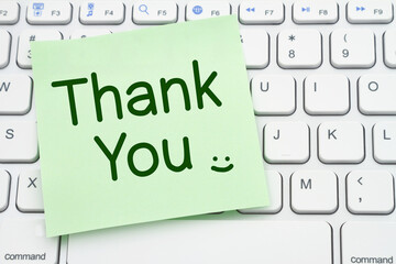 Thank You message on a sticky note on a computer keyboard