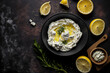 Top view of a gray bowl holding a whipped feta cheese dip with garlic and lemon. Greek food concept. Generative AI